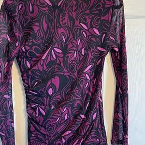 Vivid beautiful colors with a V neckline. Gathered on the side, sheer sleeves.